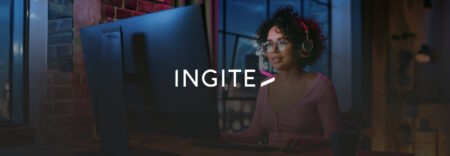 Woman with headphones working at a computer at night