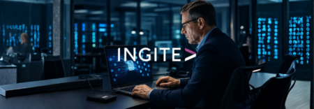 Analyst working at a dark workstation with several monitors showing code and data